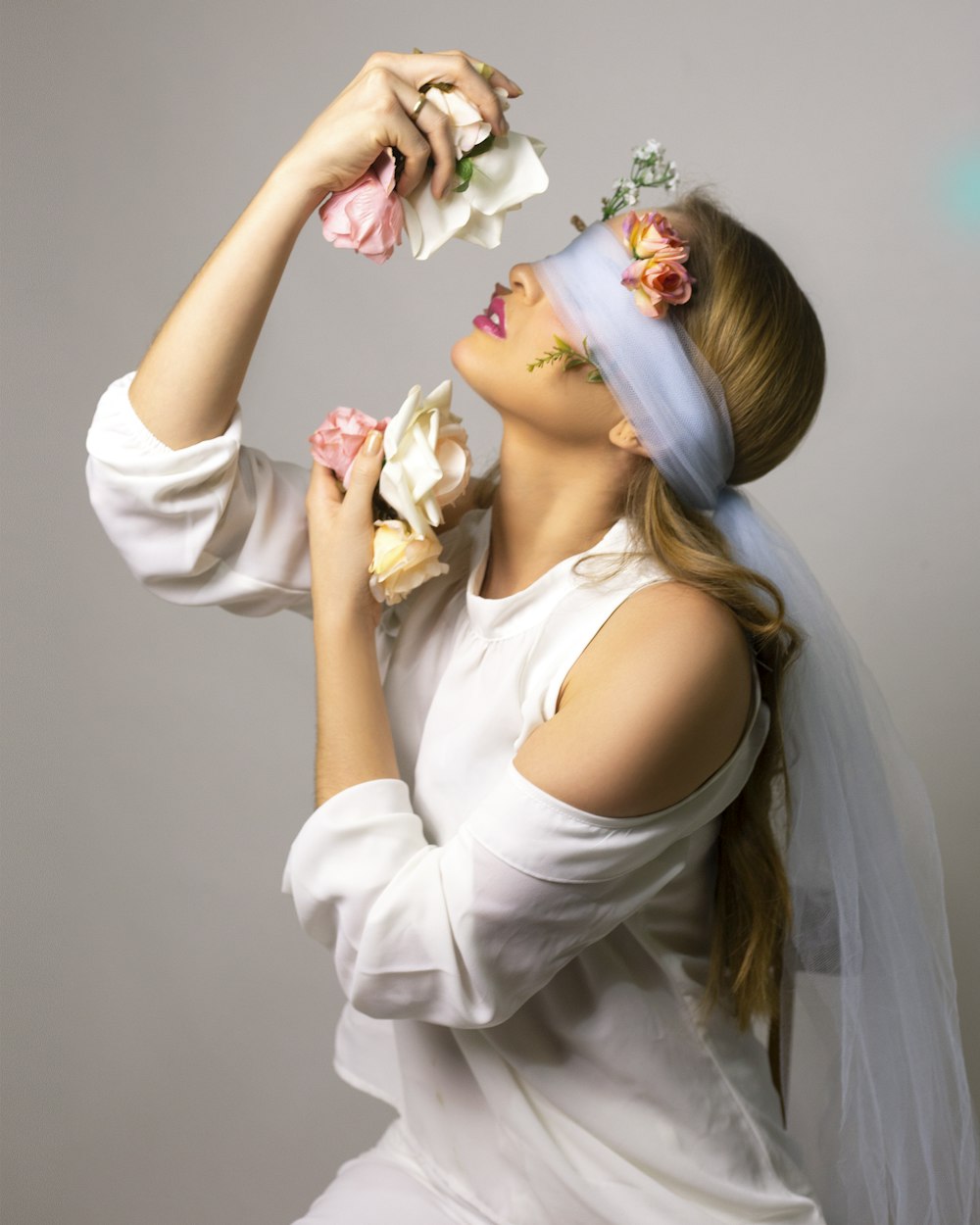 a woman wearing a veil and flowers in her hair