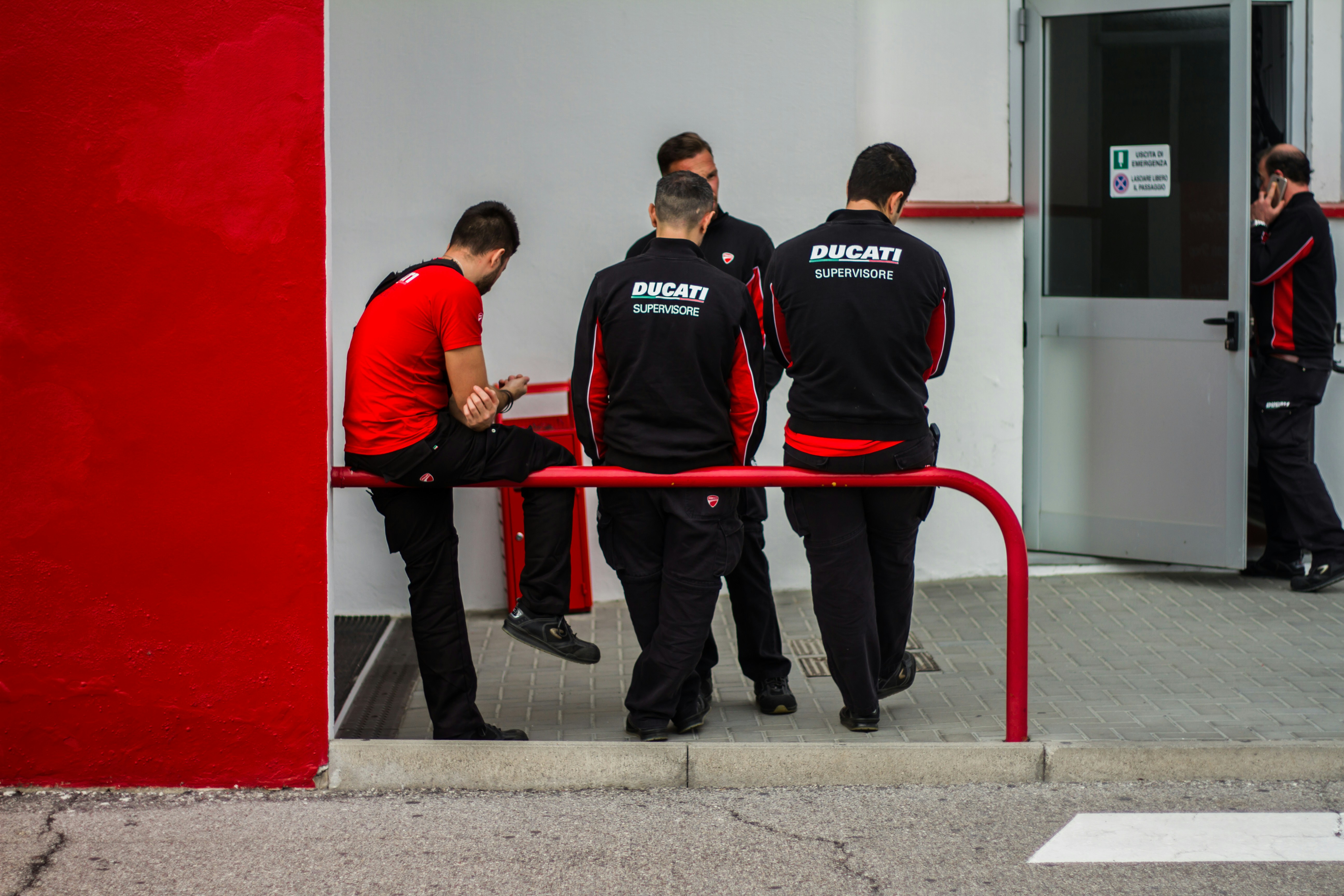 Mechanic inspecting a Nissan Rogue under a lift during 60,000 mile service