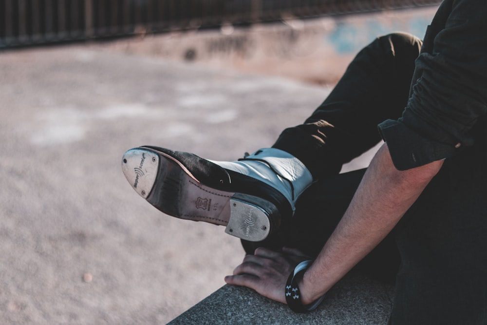 person in black and white nike sneakers