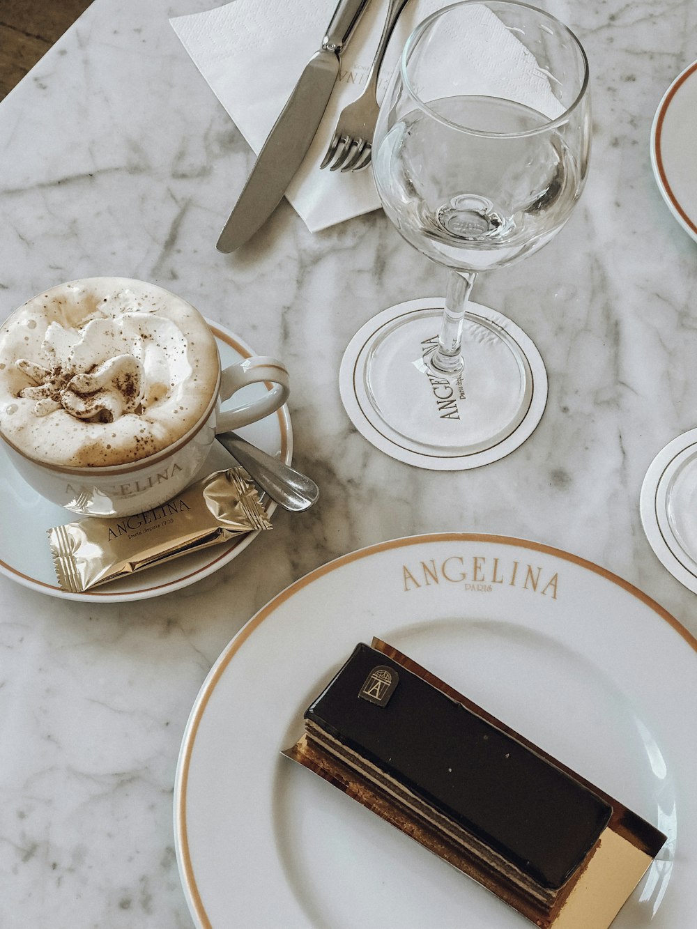 clear glass cup beside white ceramic plate with bread