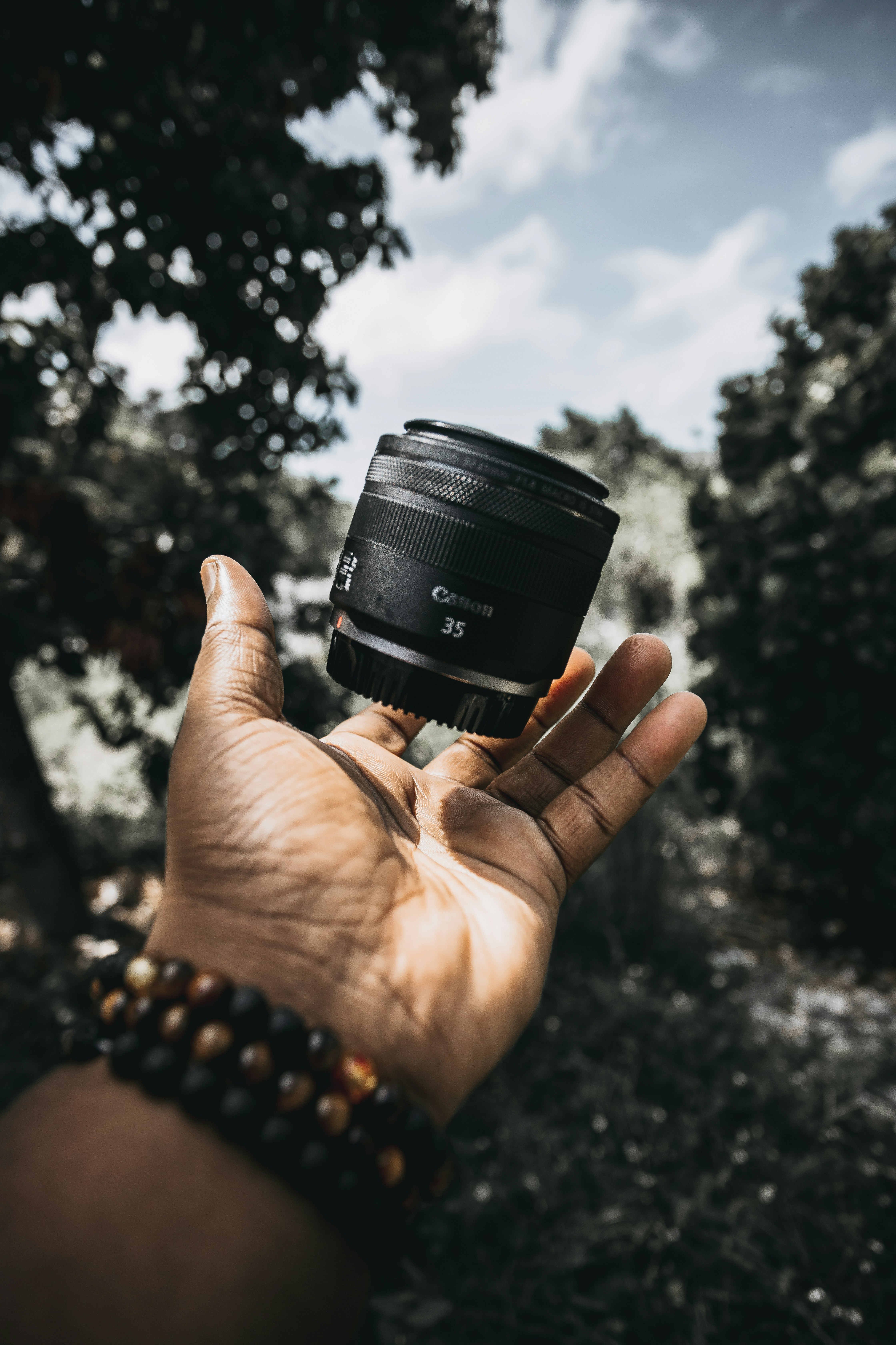 person holding black camera lens