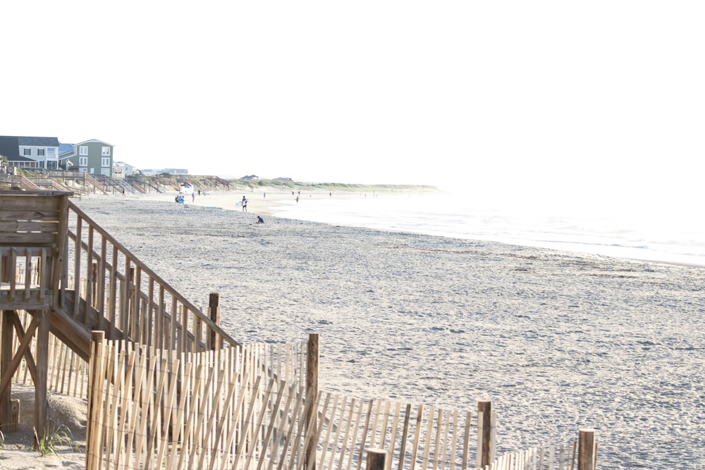 white wooden fence on beach