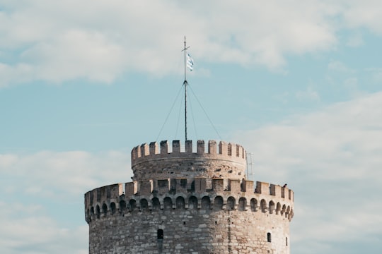 brown brick building under blue sky during daytime in White Tower of Thessaloniki Greece