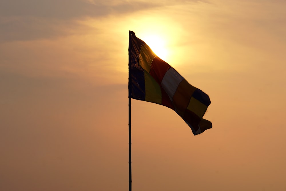 yellow and blue flag on pole during daytime