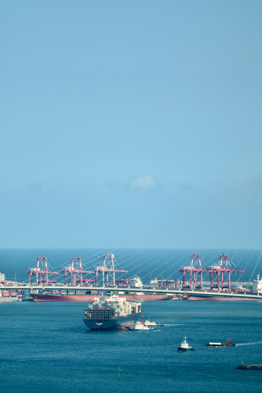 white and red ship on sea under blue sky during daytime