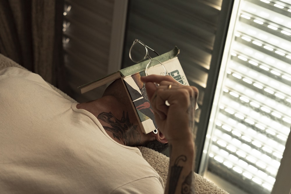 person holding a green and white book