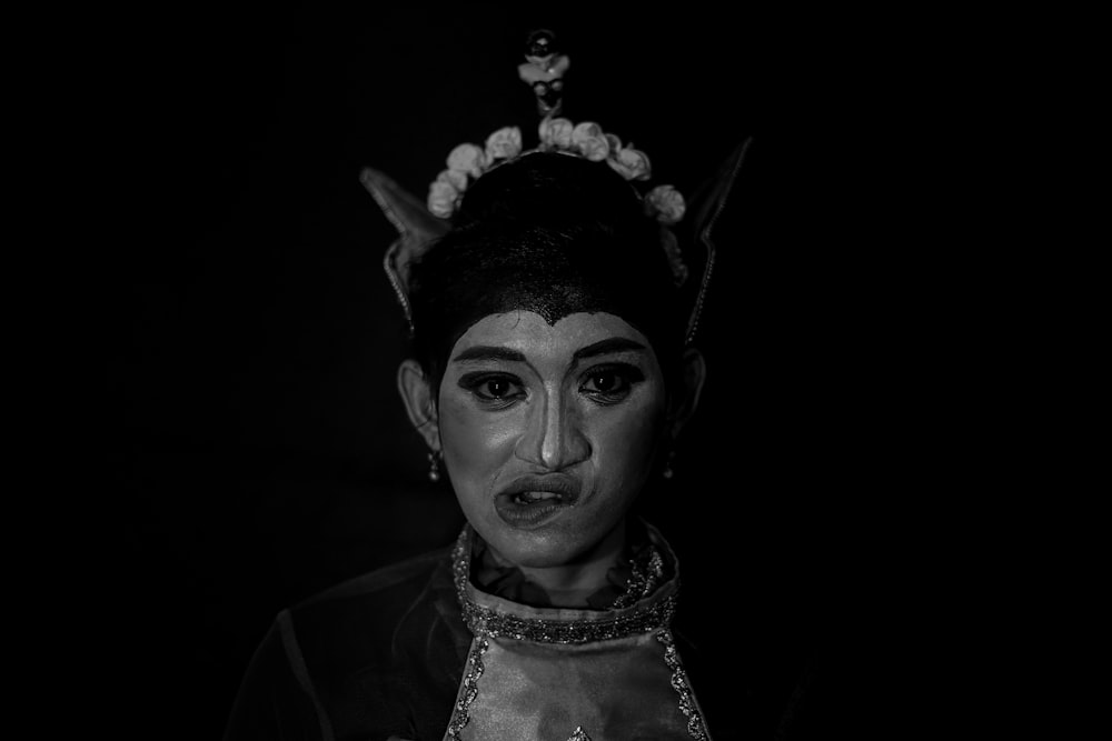 grayscale photo of woman wearing white and black floral head dress