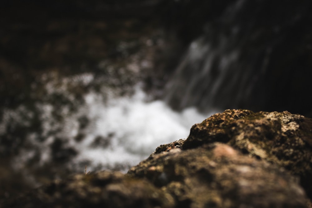 water falls on brown rock