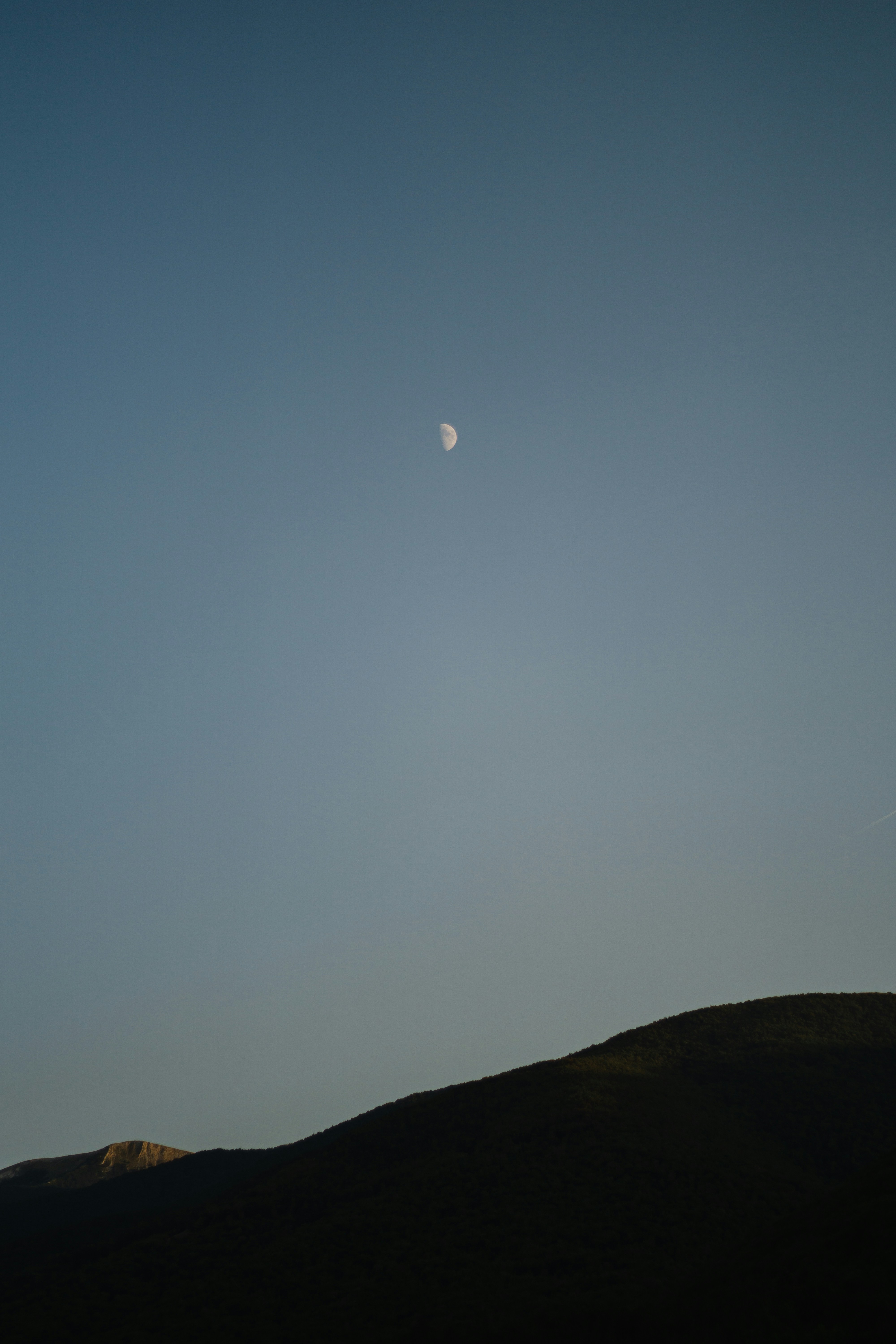 silhouette of mountain under blue sky during daytime