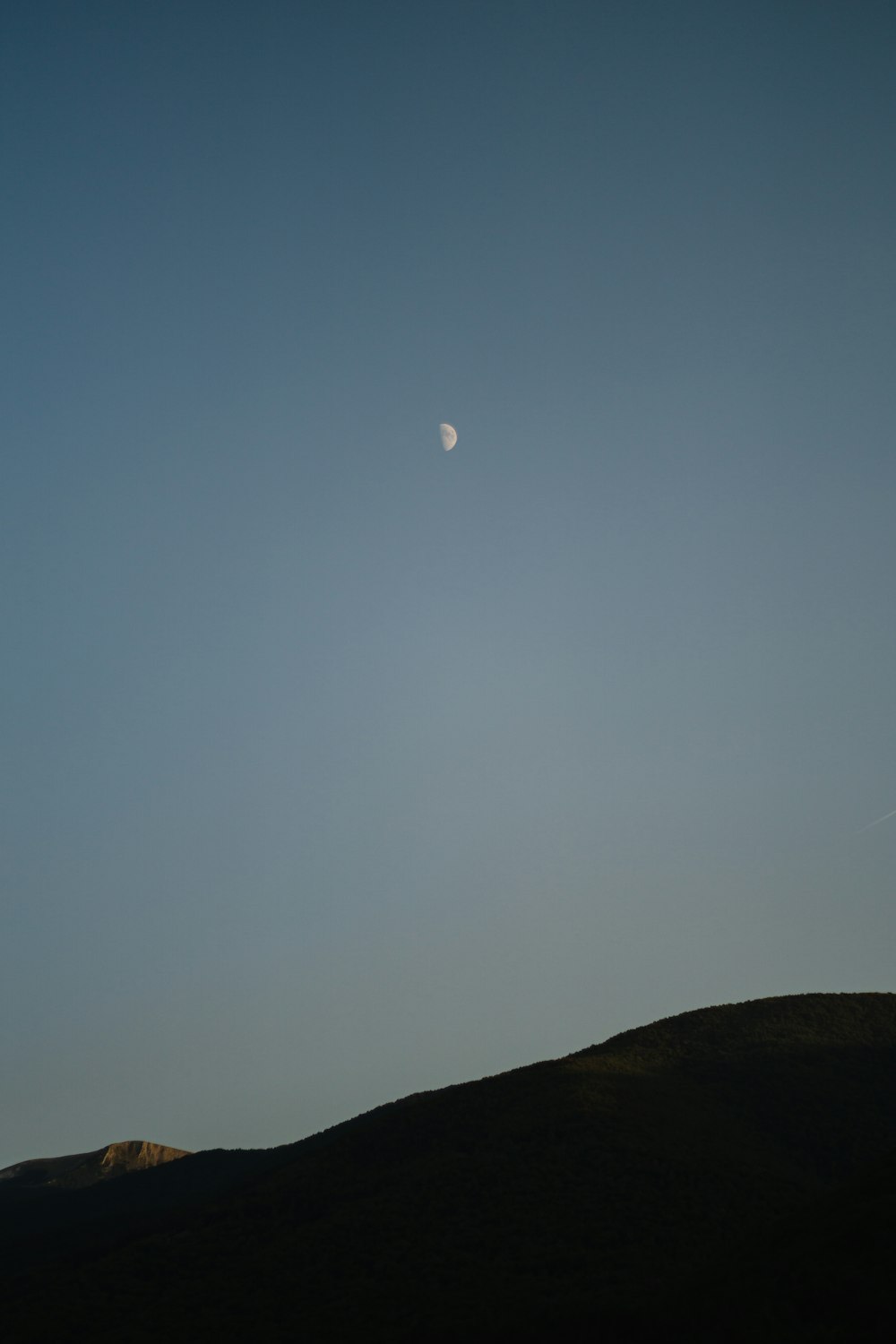 silhouette of mountain under blue sky during daytime