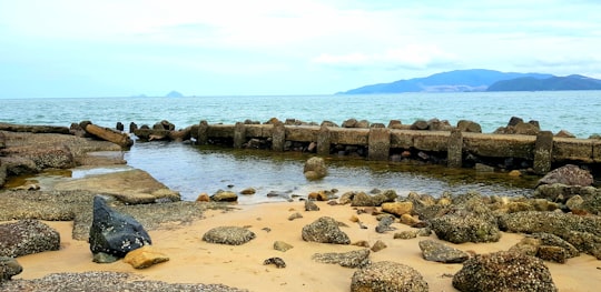 brown rocks on sea shore during daytime in Nha Trang Vietnam