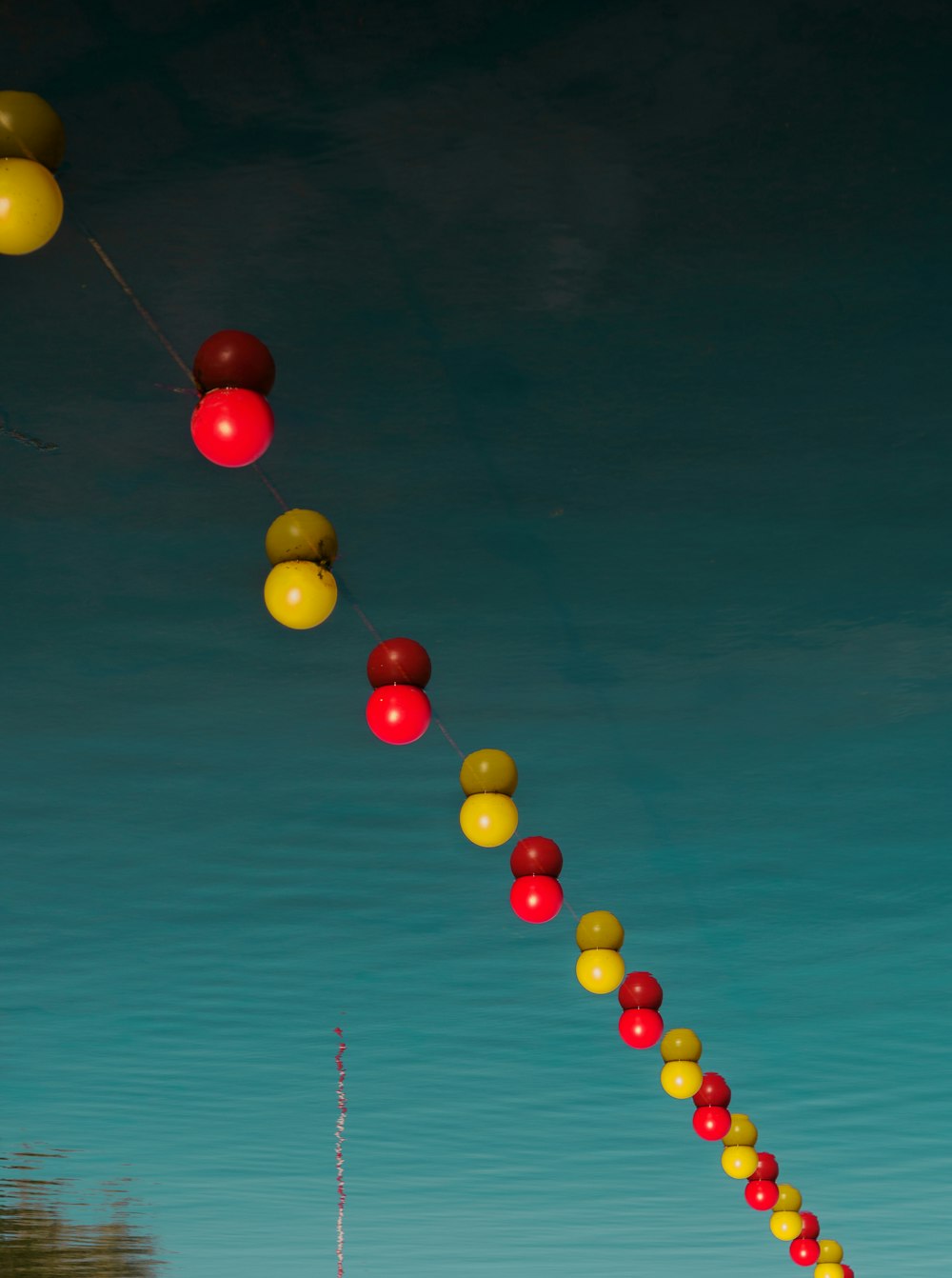 a long line of balloons floating in the air