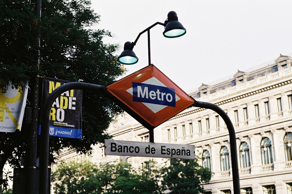 black street light near green trees during daytime