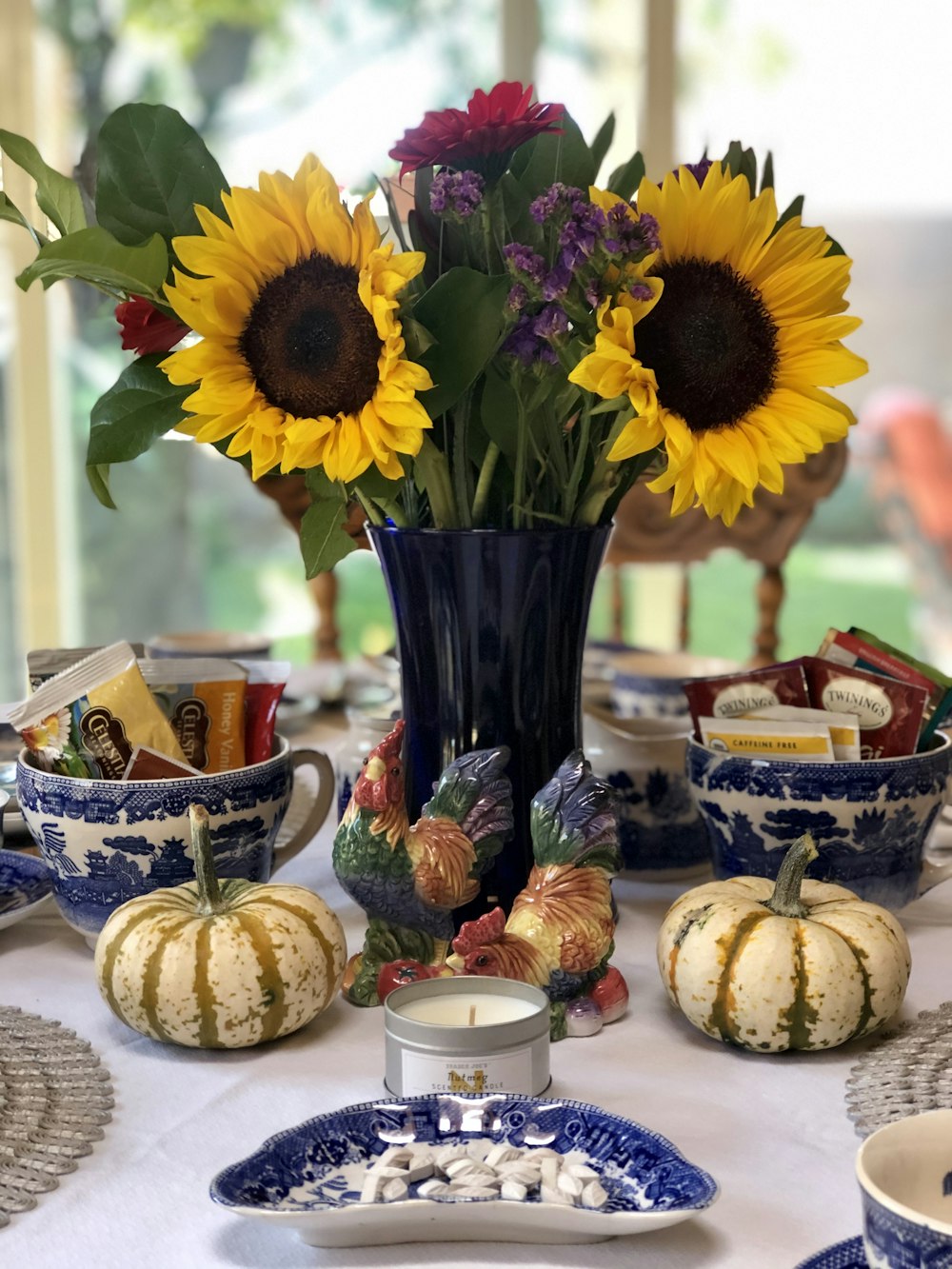 yellow sunflower in blue vase