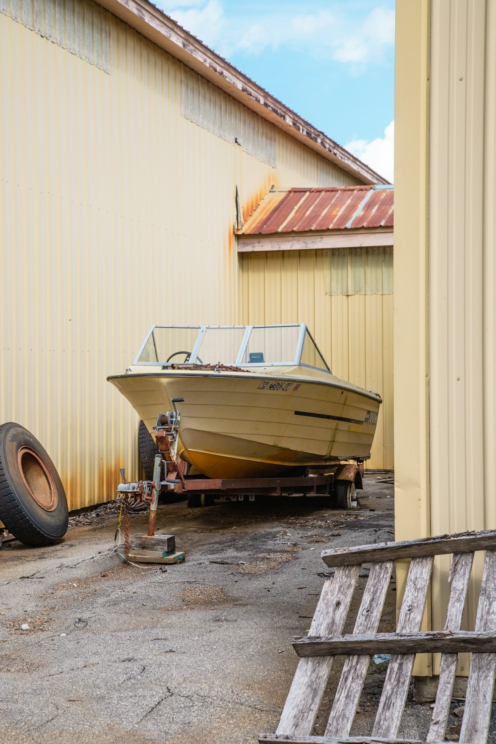 white and brown boat on brown wooden dock during daytime