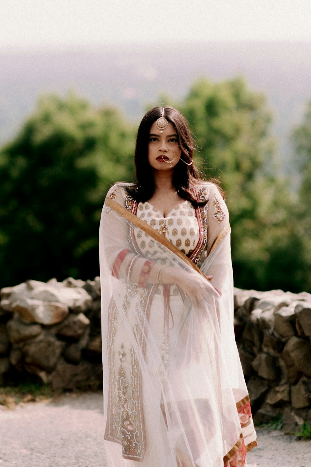 woman in white dress standing on rock during daytime