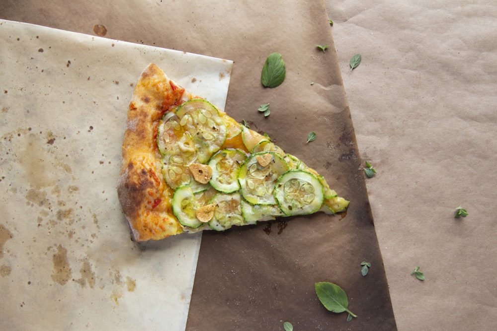 brown and green pizza on brown paper