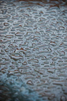 Water droplets beading on a newly waterproofed terrace floor, showing effectiveness.