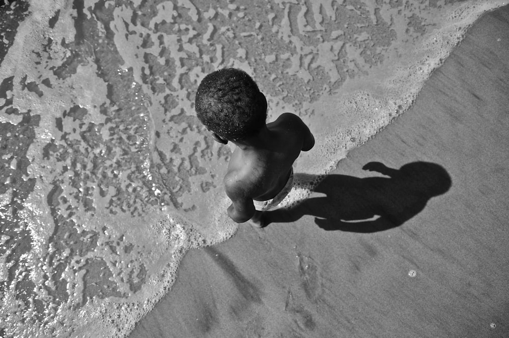 grayscale photo of man in water