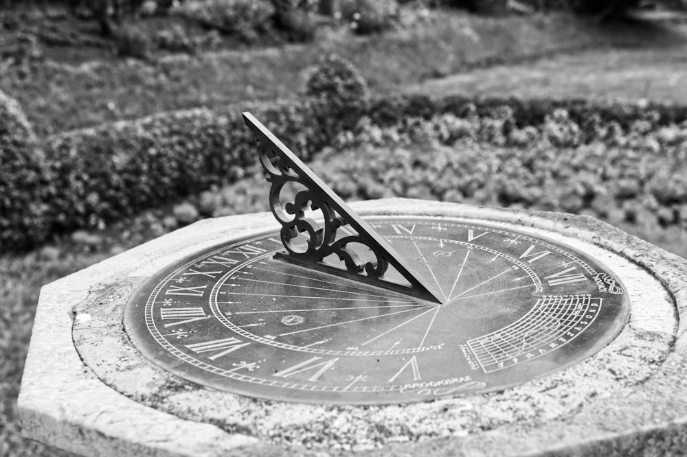 grayscale photo of round analog clock