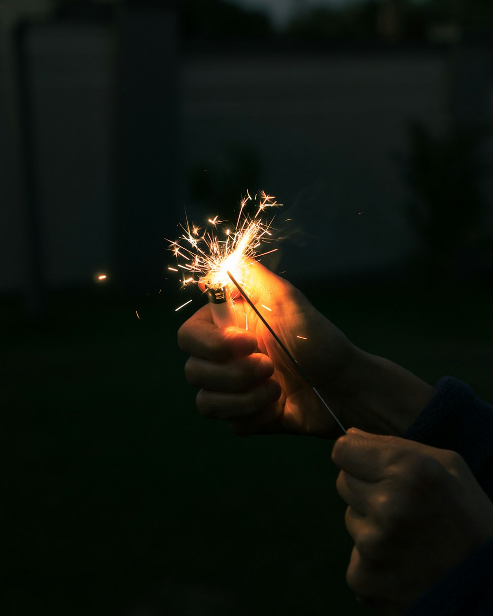 person holding sparkler during nighttime