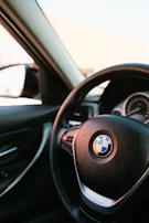 Close-up of a BMW car interior highlighting the dashboard and original accessories.
