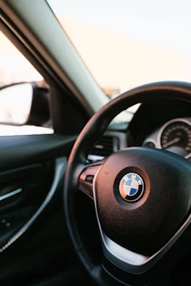 Close-up of a BMW car interior highlighting the dashboard and original accessories.