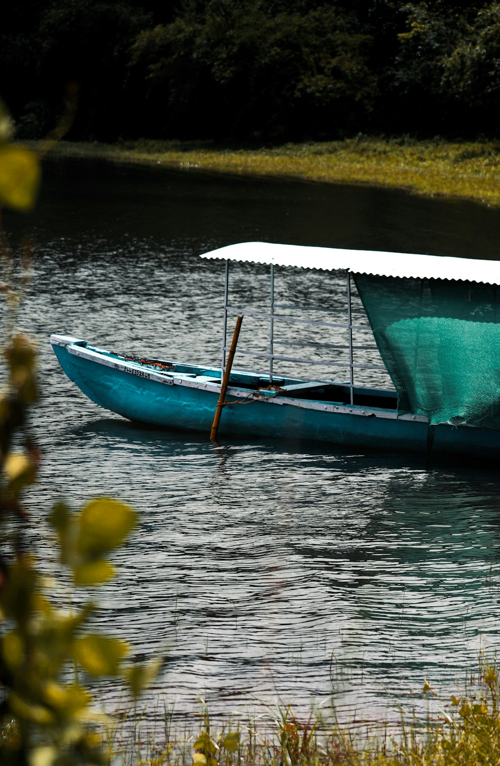 blue and white boat on water during daytime