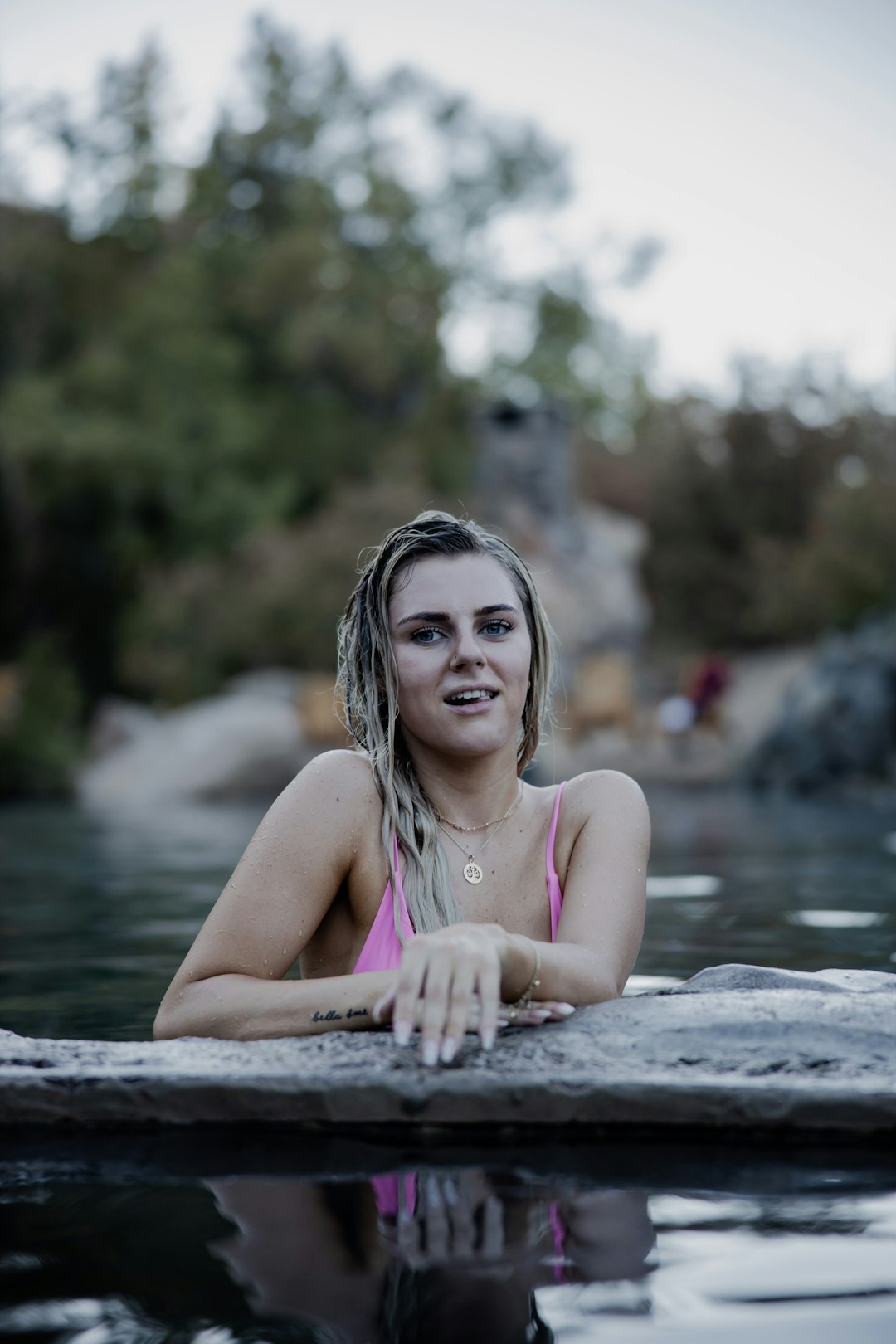 woman in pink tank top on water during daytime