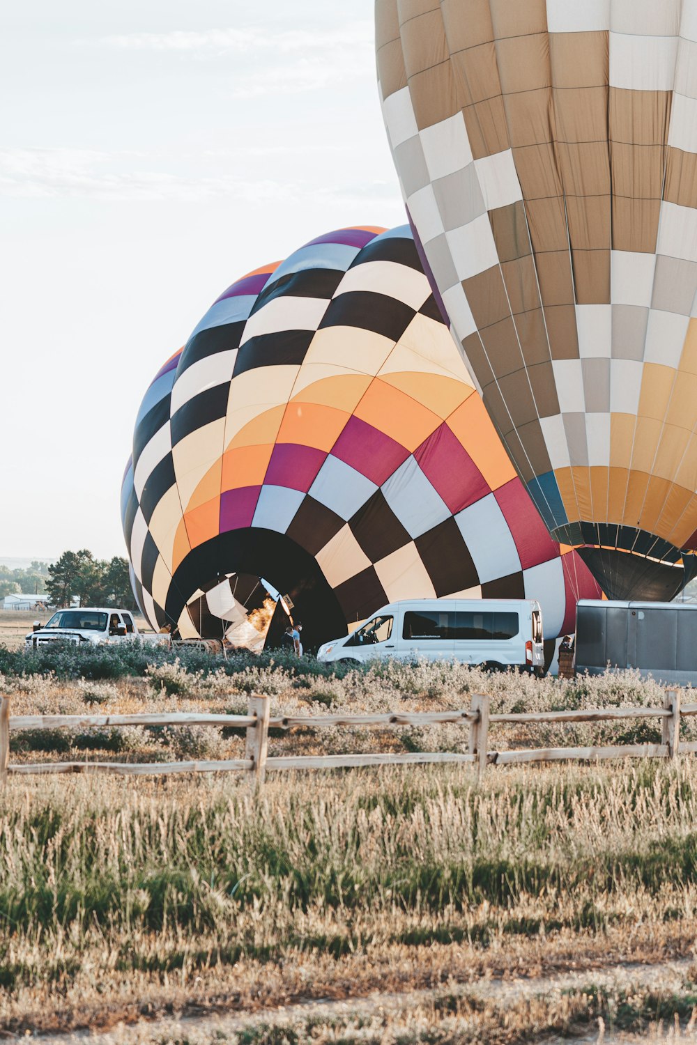 yellow blue and red hot air balloon on brown field during daytime