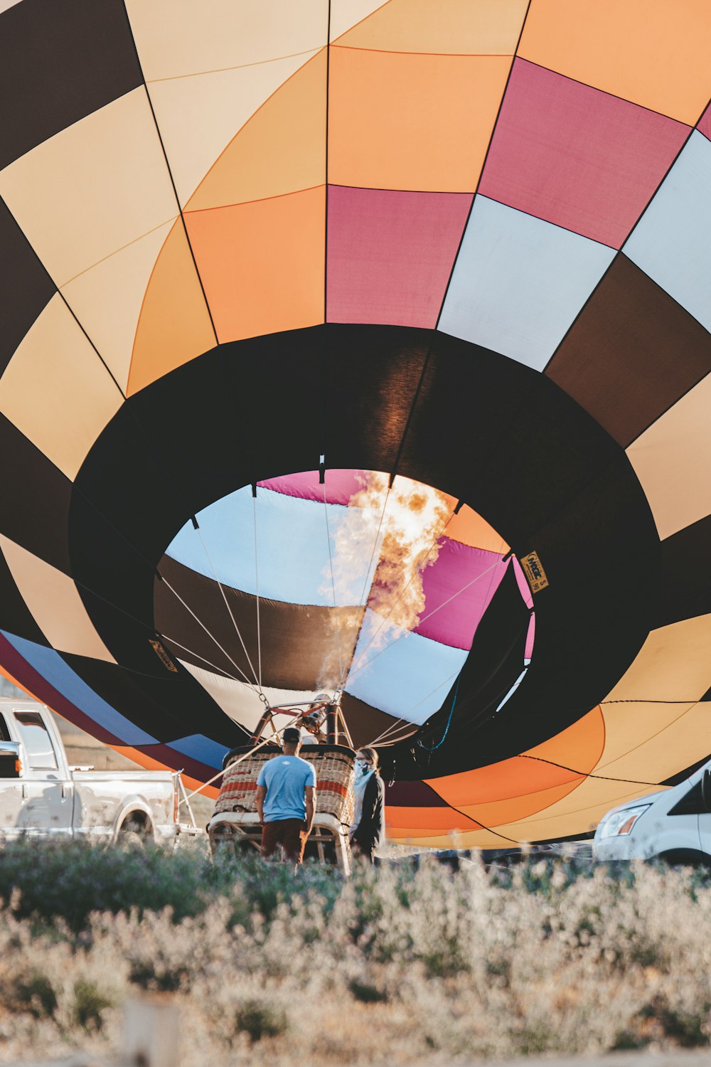 woman in white shirt and blue denim jeans standing in front of hot air balloon