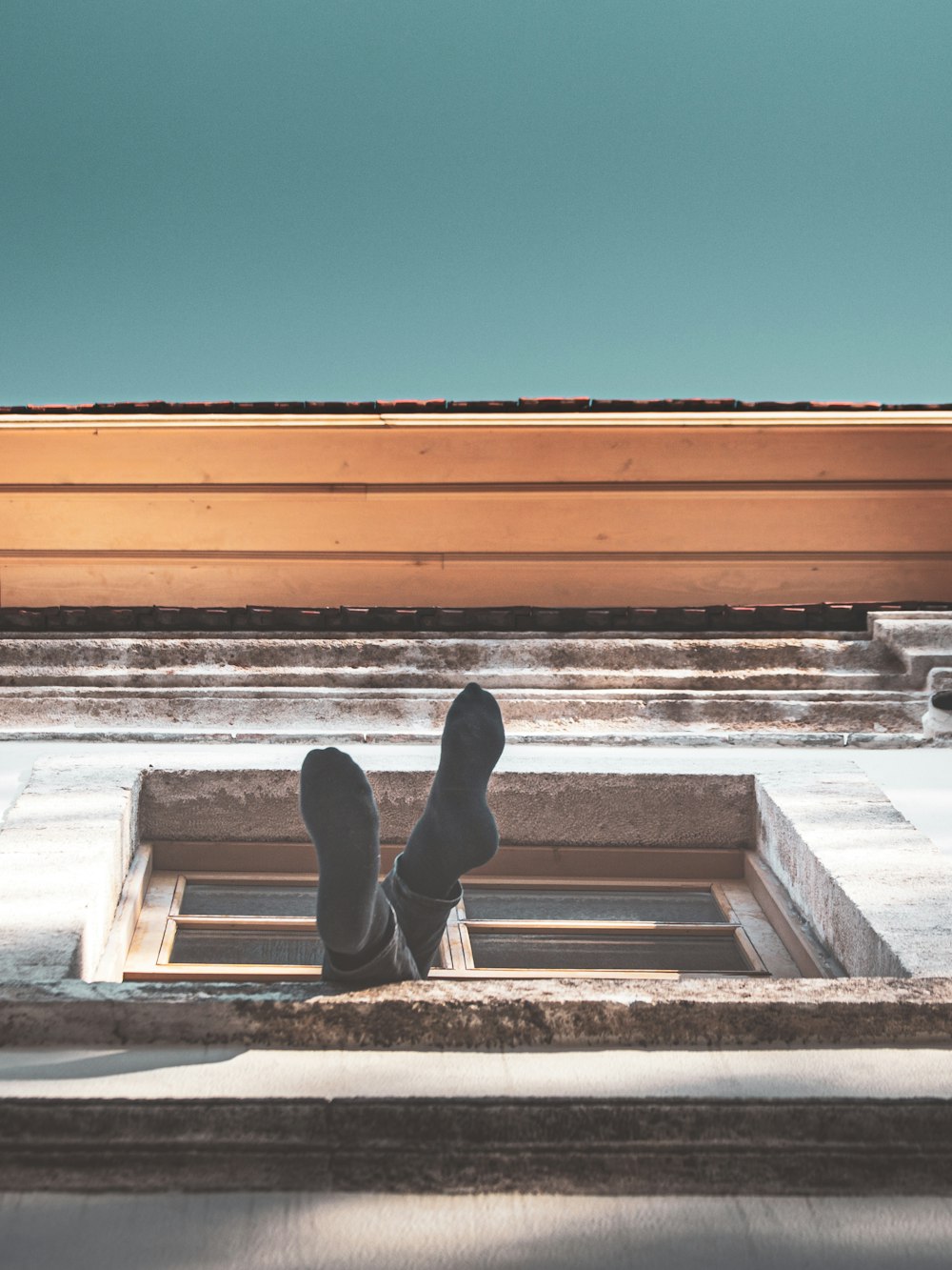 person in black pants and black shoes standing on white concrete stairs during daytime