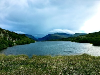 A serene landscape with soft morning light over a calm lake.