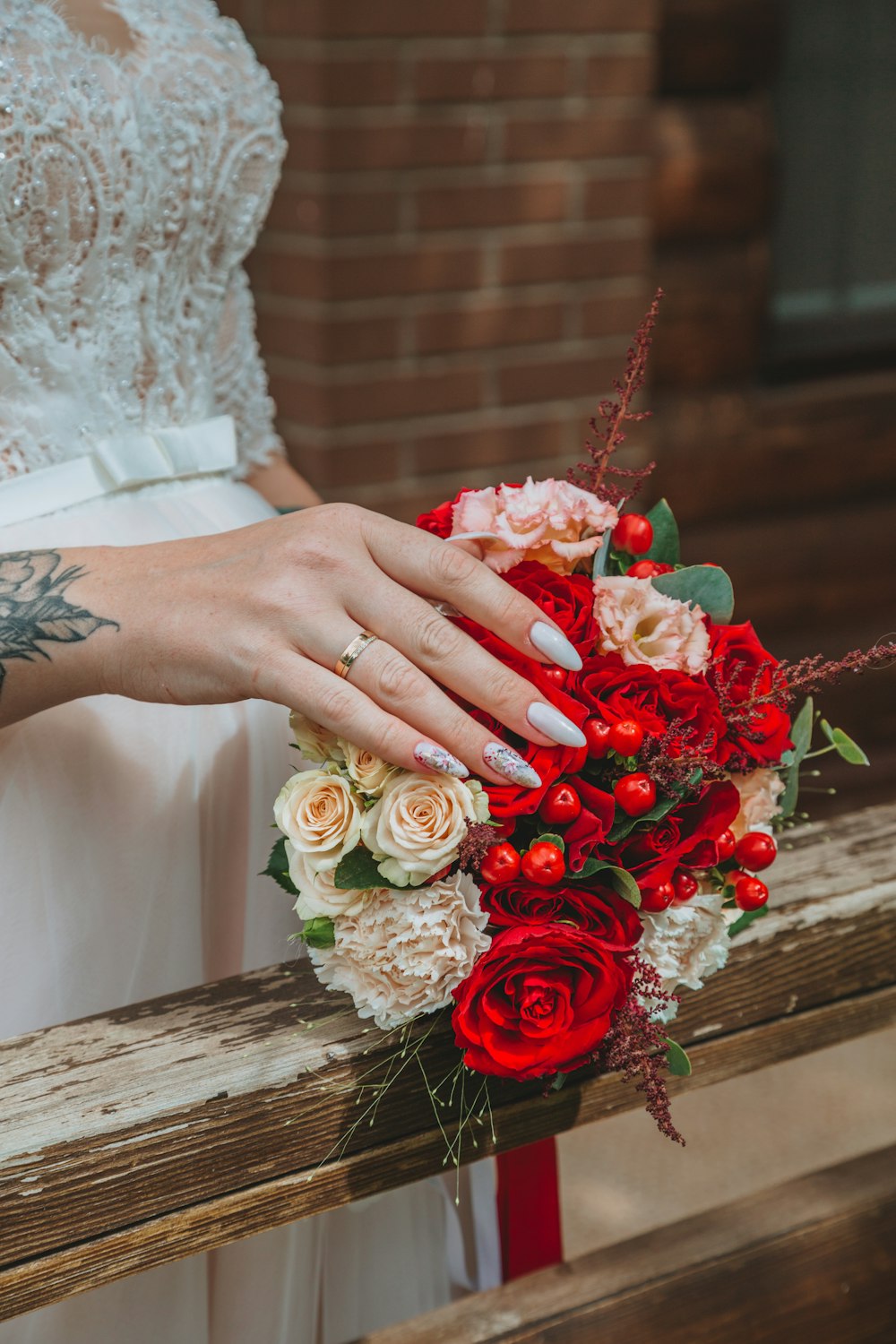 person holding bouquet of red roses