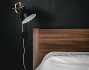 black and white table lamp on brown wooden nightstand