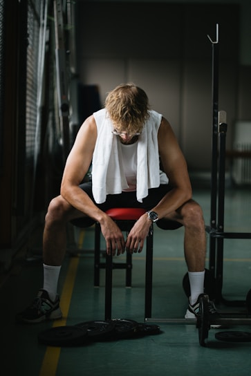 Close-up of a sleek, moisture-wicking gym shirt with ironfits logo on a gym bench.