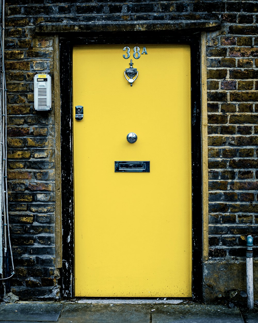 yellow door with white and black wall