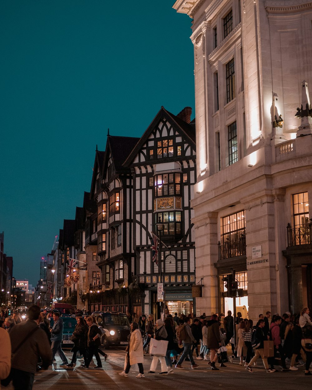 people walking on street near building during night time