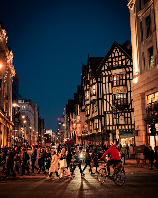 people walking on street during night time in London United Kingdom