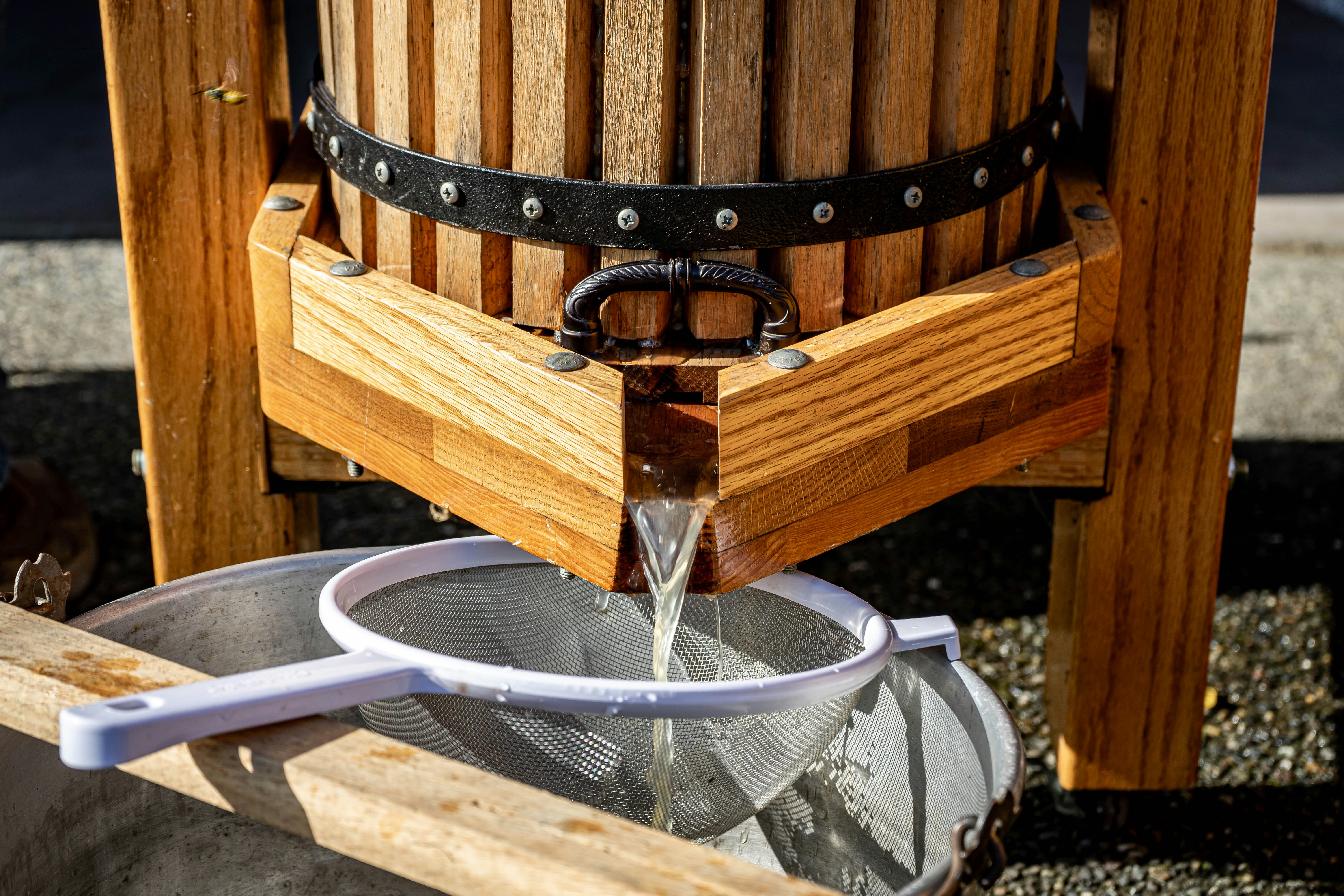 silver and brown beaded necklace on brown wooden table