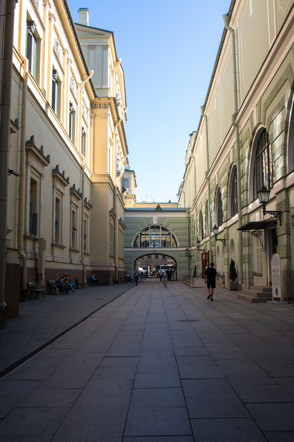 people walking on sidewalk in between buildings during daytime