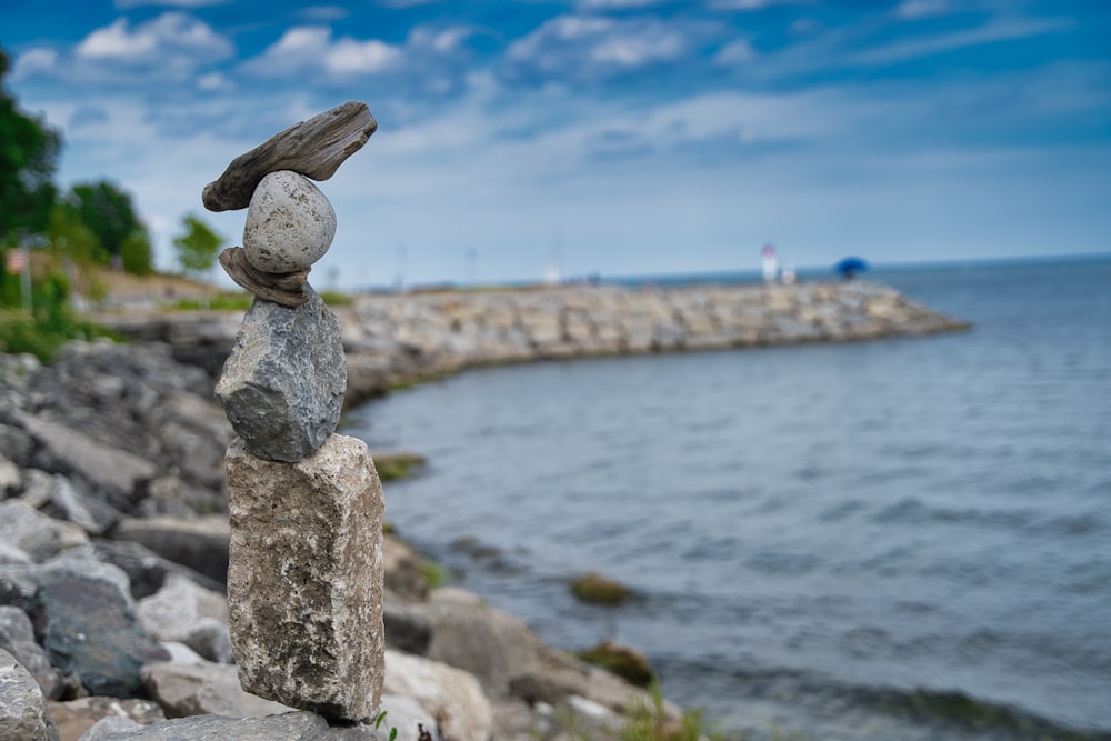 gray stone near body of water during daytime