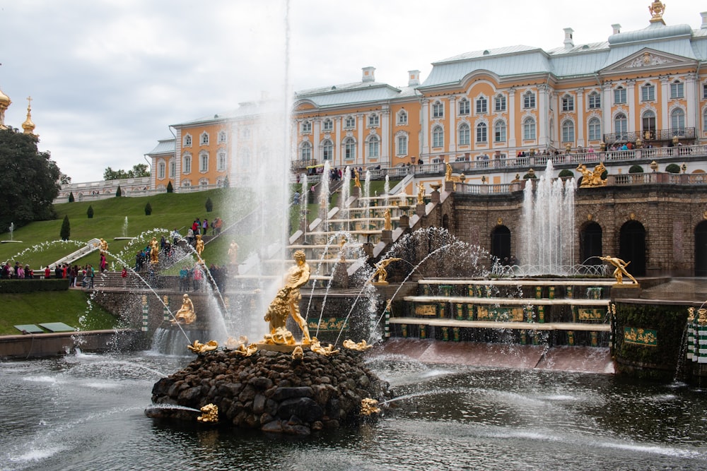 water fountain in front of white concrete building during daytime