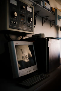 A close-up of a classic beige desktop computer with a CRT monitor and mechanical keyboard.