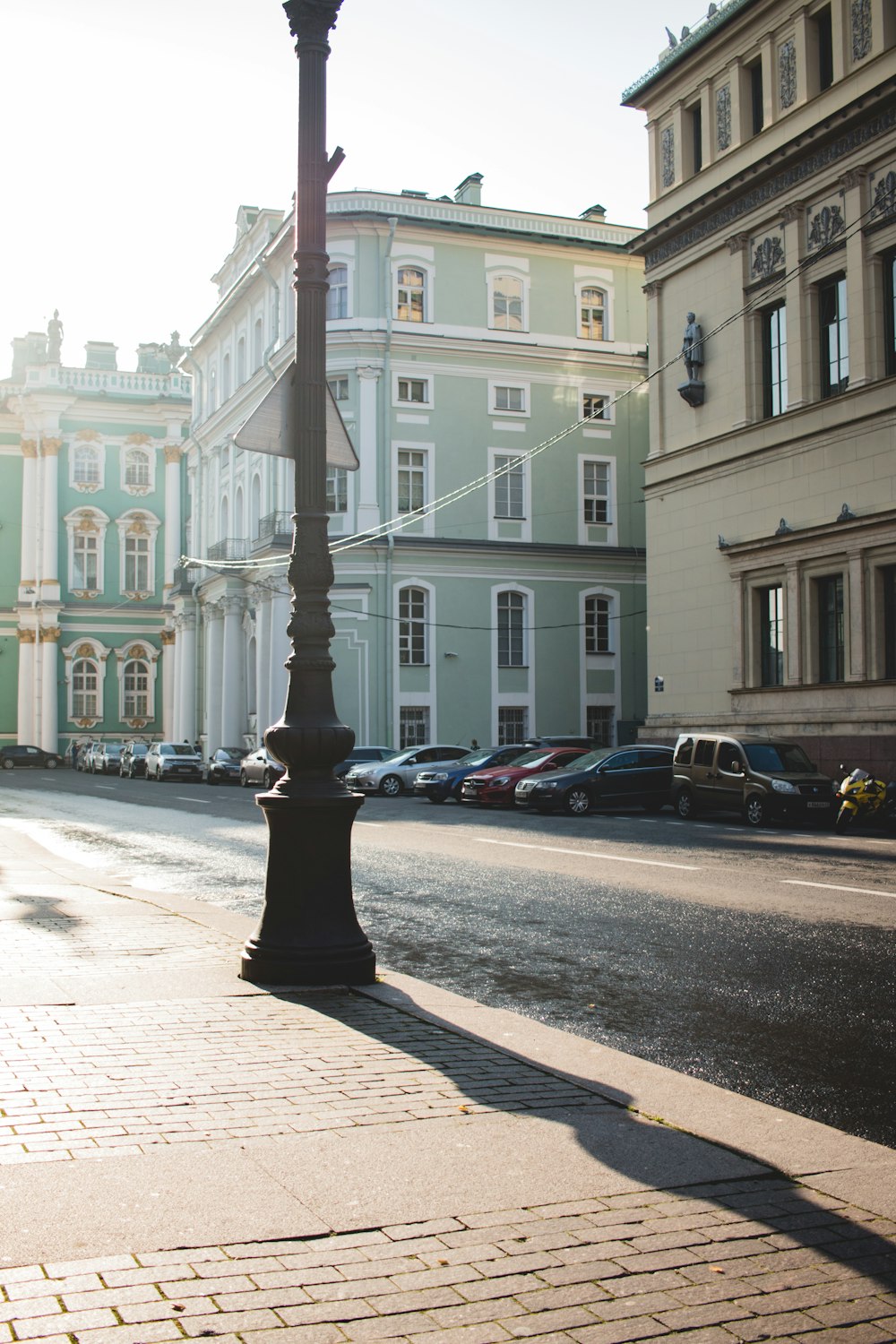 cars parked in front of white building during daytime