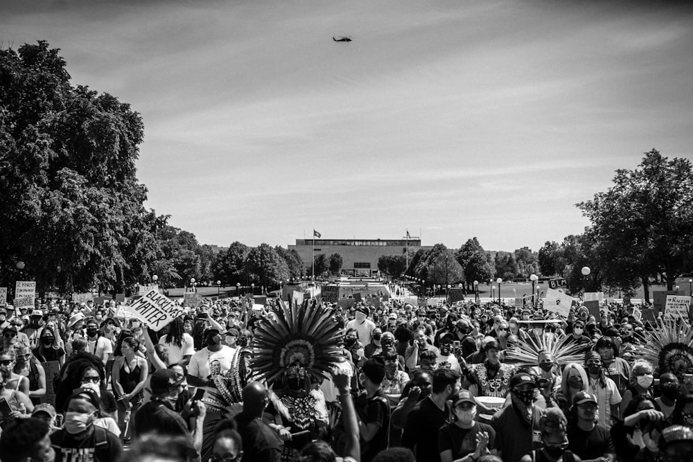 grayscale photo of people in the street