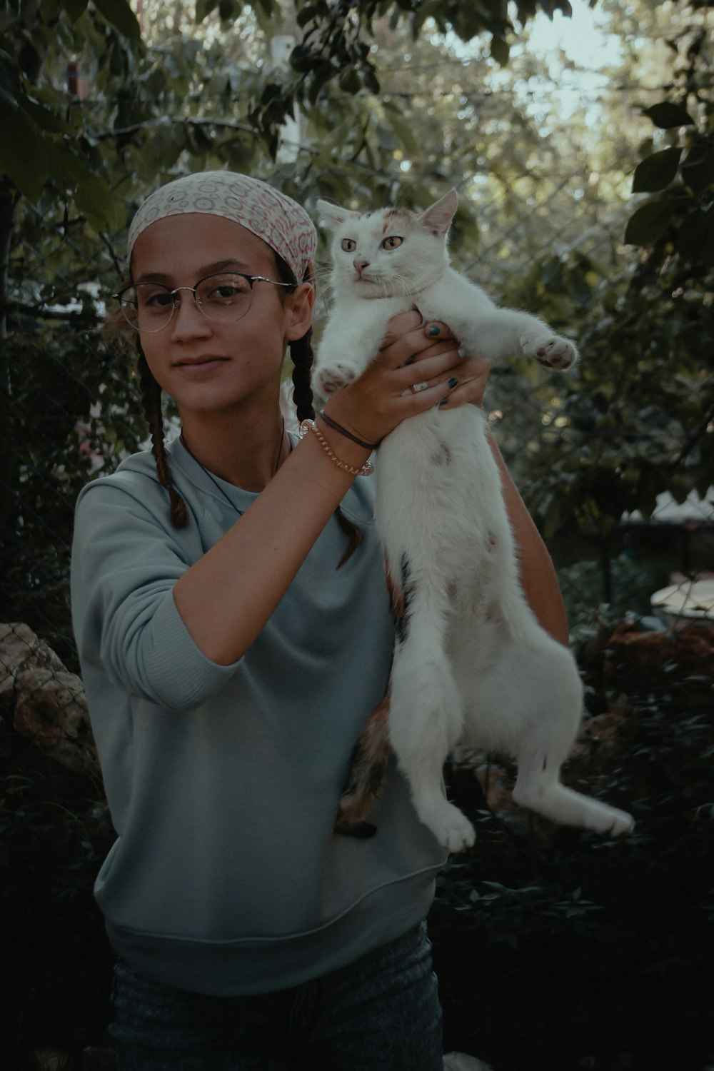 woman in gray crew neck t-shirt holding white cat