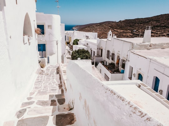 white concrete building under blue sky during daytime in Sifnos Greece