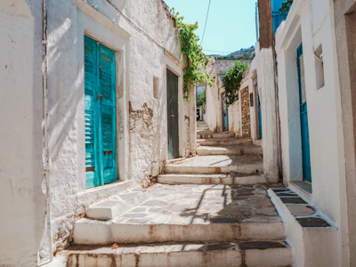 A blue door in a white wall in the upper town at Symi