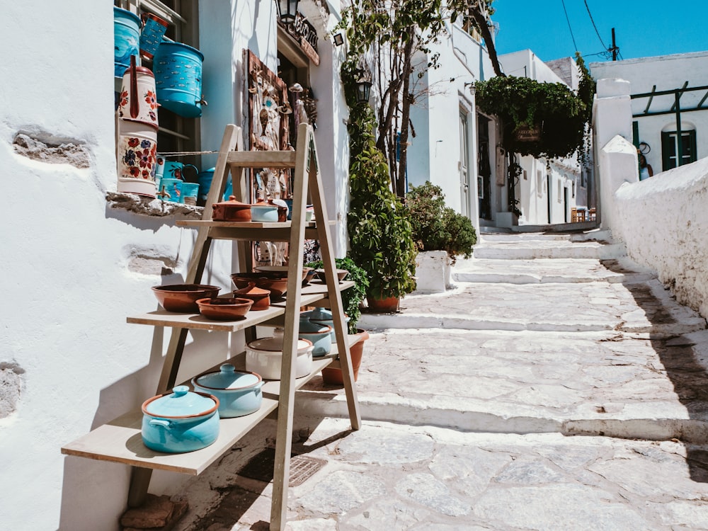 brown wooden ladder beside white concrete building during daytime